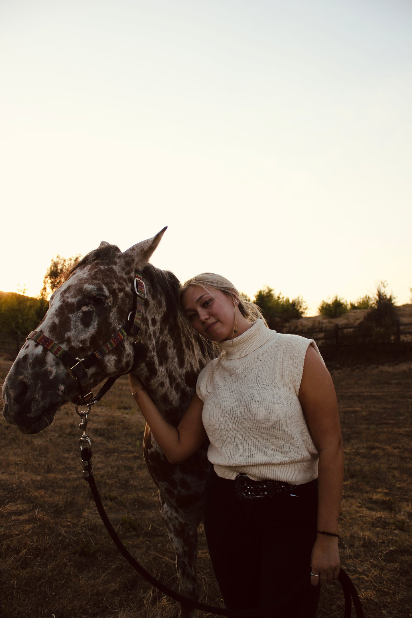 Cream sleeveless turtleneck sweater